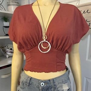 A maroon, red-ish blouse top.